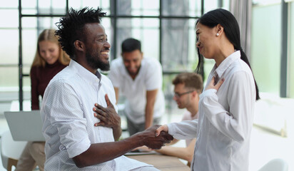 Welcome to our team Shaking hands while working in the creative office