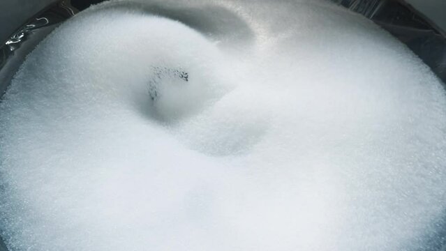 Polymer material processing at the industrial production plant. Factory machinery deals with the polymer material processing. Making ecological textile by processing the polymer material.