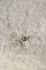 Christmas or New Year decoration in the shape of a snowflake on a fluffy background	