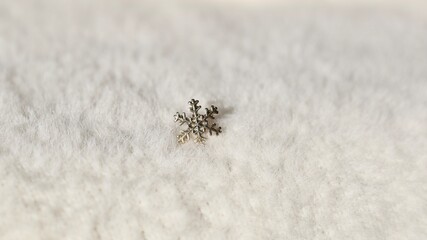Christmas or New Year decoration in the shape of a snowflake on a fluffy background