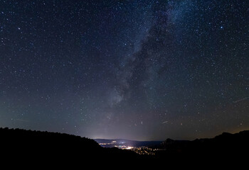 The galactic cloud of the Milky way setting over the city of Sedona, Arizona.
