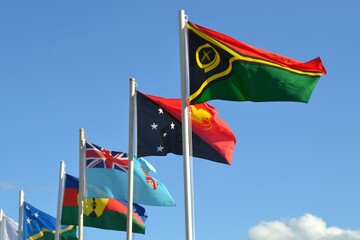 Flags of Pacific nations flying together with Fiji, Solomon Islands. Papua New Guinea and Vanuatu