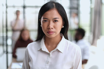 Young beautiful Asian business woman consultant , portrait of an employee looking at the camera