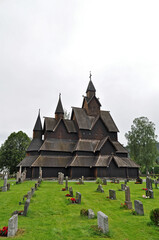 Fototapeta na wymiar Old memorial wooden church with cemetery in Norway