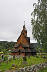 Fototapeta na wymiar Old memorial wooden church with cemetery in Norway