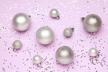 Wallpaper greeting card Merry Christmas holiday composition with silver toy ball decoration on lilac violet purple glitter background. Xmas New Year winter design idea concept. Top view, Flat lay. 