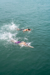Young men swimming in the sea