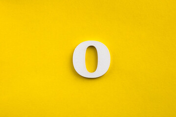 Fototapeta na wymiar letter O uppercase - white wood letter on yellow color background