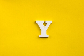 Fototapeta letter Y uppercase - white wood letter on yellow color background obraz