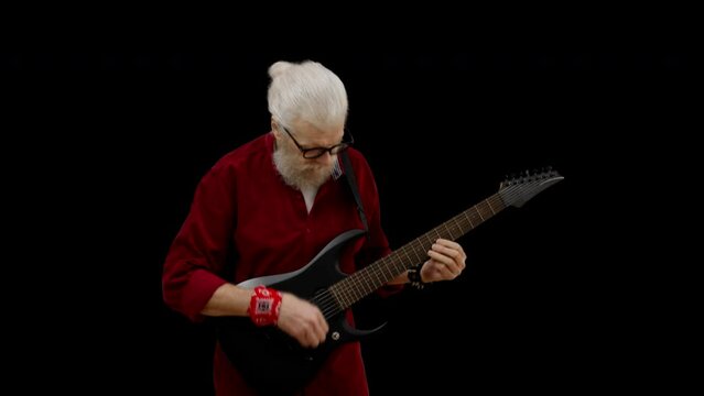 Man in his 60s playing electric guitar, forever young, rock and roll, hobby