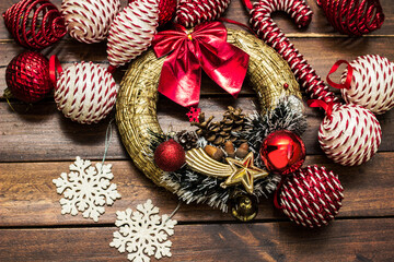 Christmas background wreath with red and white balls decoration, for tree branches, candy canes, and snowflakes