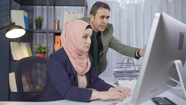 Team work. Muslim business woman and her male colleague work in the office.
Businesswoman and her colleague run the business together and rejoice.

