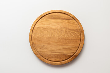 Empty wood round cutting board on white background