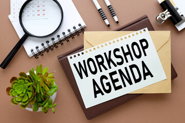 WORKSHOP AGENDA different notebooks on the table. next to the calendar. text on paper