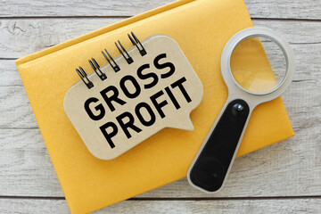 GROSS PROFIT word on paper on yellow notepad on table - obrazy, fototapety, plakaty