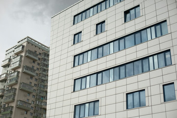 Building with windows in city. High house. Many floors in building. Modern architecture.