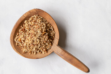 Chopped Walnuts on a Wood Paddle