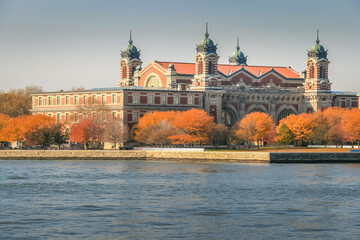 Ellis Island skyline from hudson river at golden autumn in New York , USA