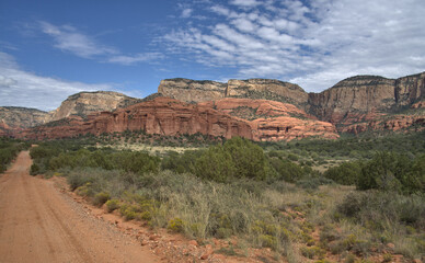 Twisting red dirt road leading to a historic cliff dwelling site called Honanki