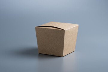 Closed cardboard box on grey background.