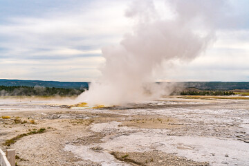 Fototapeta na wymiar Clepsydra geyser on the Fountain Paint Pot Trail in Yellowstone National Park.