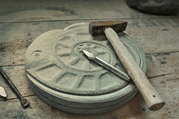 background with various tools for working with stone. Stone sculptures in the background in the workshop. hand made © svitlychnaja
