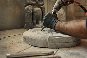 The craftsman works with stone with different tools. atmospheric photo. Sculpture making, handmade