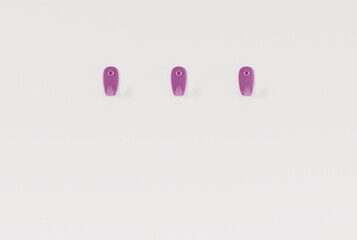 Hangers on a light wall. Minimalist concept, hanging towels, clothes on hangers. 3D render, 3D illustration.