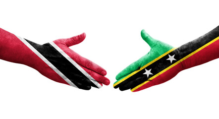 Handshake between Saint Kitts and Nevis and Trinidad Tobago flags painted on hands, isolated transparent image.