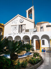 Fototapeta na wymiar The parish Church of our Lady of Mercy in Fuengirola on the Costa del Sol in southern Spain A beautiful modern Parish Church in a small square with impressive statues