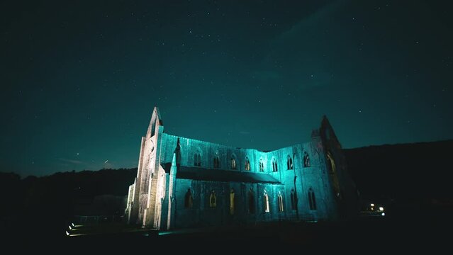 Time lapse of starry sky over ancient ruins of Tintern Abbey, Wales, UK