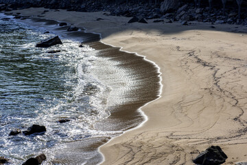 The big breaking waves during a strom at the beautiful sea shore background the rock island and...