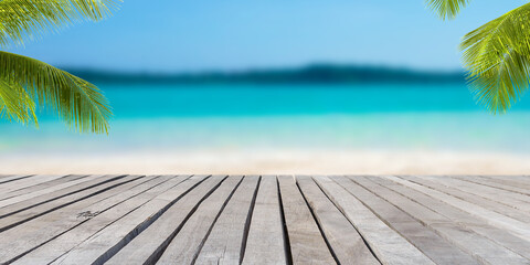 Empty wooden table in front of blurred background of the sea, sand, mountain, coconut palm, blue sky among bright sunlight on a clear day. Can be used for display or montage for show your products.