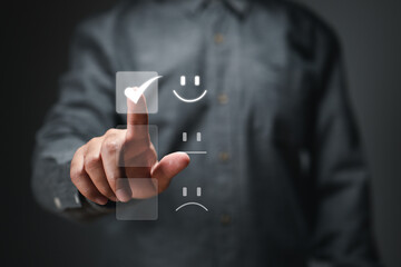 Business people are touching the virtual screen on the smiling smiley face icon to express happiness with the customer service idea. extremely impressed rating