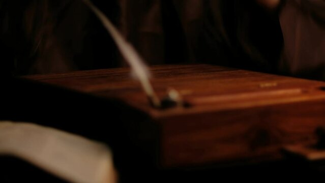 Video of old monk takes a manuscript out of the document box, signs it, wet paperweight, and puts it back.