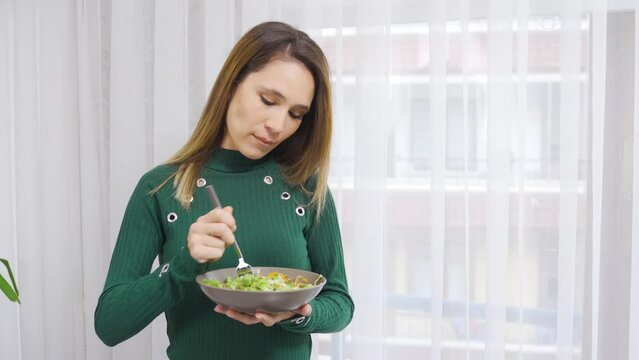 Healthy diet. The woman consumes vegetables to stay fit and fit.
Eating vegetables. Healthy living woman eats vegetables.

