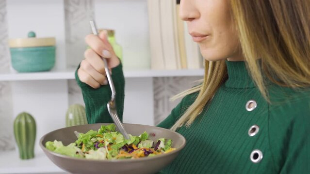 Living healthy. Woman eats salad to stay fit and fit.
Healthy diet. The woman consumes vegetables to stay fit and fit.
