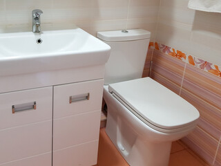 Close-up of the washbasin and toilet bowl in a modern beautiful bathroom