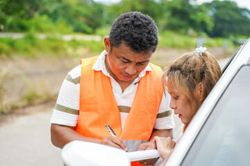 Closeup the insurance company officers for customers to sign a claim report form after an accident....
