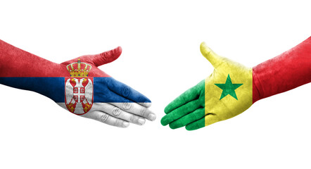 Handshake between Senegal and Serbia flags painted on hands, isolated transparent image.