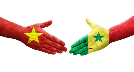 Handshake between Senegal and Vietnam flags painted on hands, isolated transparent image.