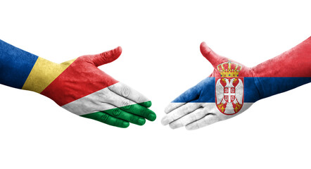 Handshake between Serbia and Seychelles flags painted on hands, isolated transparent image.