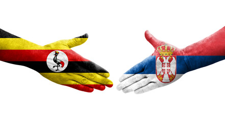 Handshake between Serbia and Uganda flags painted on hands, isolated transparent image.