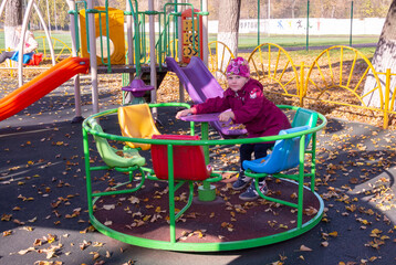 A girl is playing on the playground.