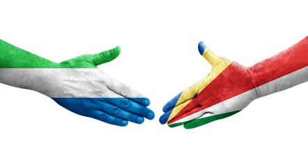 Handshake between Seychelles and Sierra Leone flags painted on hands, isolated transparent image.