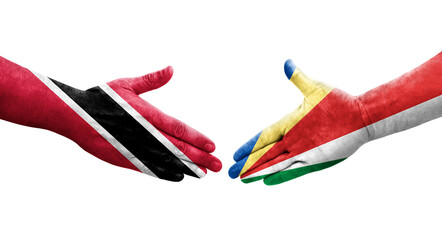 Handshake between Seychelles and Trinidad Tobago flags painted on hands, isolated transparent image.