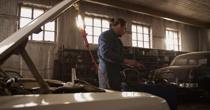 Man repairing car under sunlight