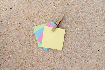 Blank colorful sticky notes holding with a clothespin