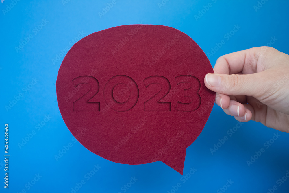 Poster speech bubble in front of colored background with the number 2023.