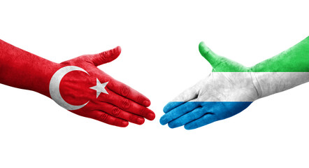 Handshake between Sierra Leone and Turkey flags painted on hands, isolated transparent image.
